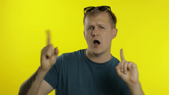 Portrait of Young Caucasian Man Posing in Green T-shirt. Happy Handsome Guy Celebrates and Dances