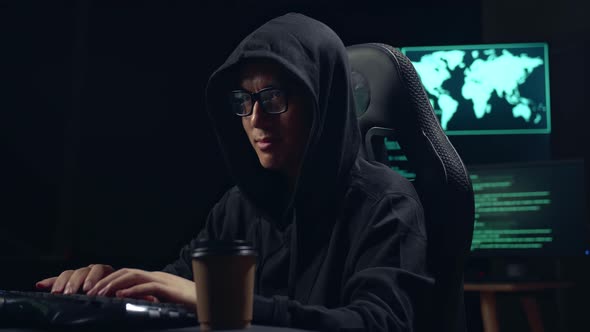 Asian Male Hacker Using Computer Hacking