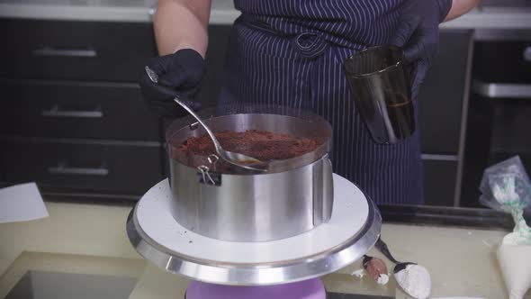 Confectionery  a Woman Soaks the Sponge Cake with Syrup