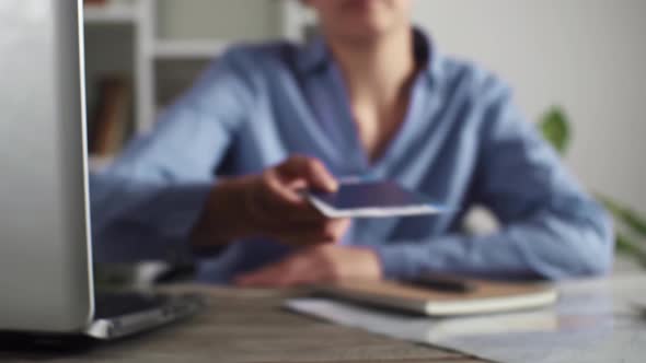 Woman Hands Passport, Tickets To Young Man At Travel Agency. Traveling While On Vacation