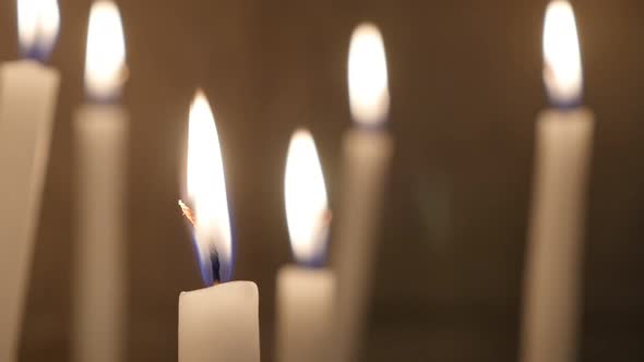 Ceremonial long  white votive wax candles burning in the cathedral hall 1920X1080 HD video - Slow bu