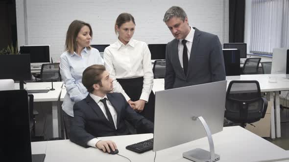 Corporate Business Team Discussing Project in front of Computer