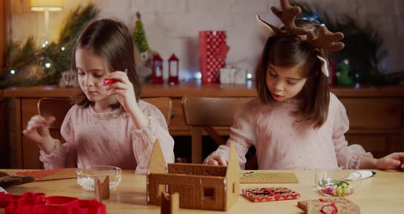 Two Cute Sisters Build and Decorate a Christmas Gingerbread House