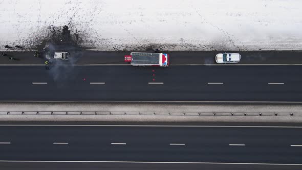 Burnt Car on the Edge of the Motorway in Winter Aerial View