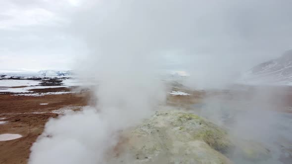 Magical dramatic scene with smoke from geothermal swamp and volcanoes in Hverir (Hverarond) valley i