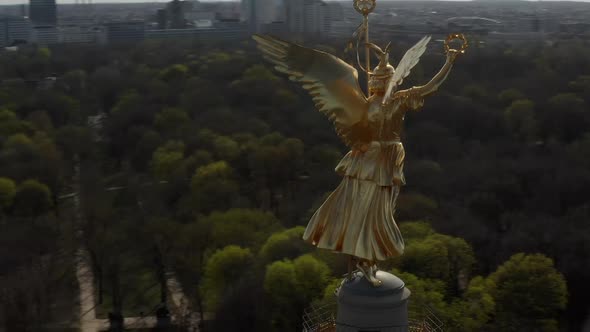 AERIAL: Close Up Circling Around Berlin Victory Column Golden Statue Victoria in Beautiful Sunlight