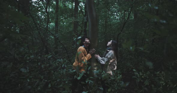 Man and Woman hug tree in forest