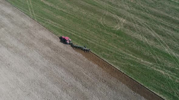 Countryside and Agriculture Grain Sowing Farm Tractors Plow the Earth in Field View From Height