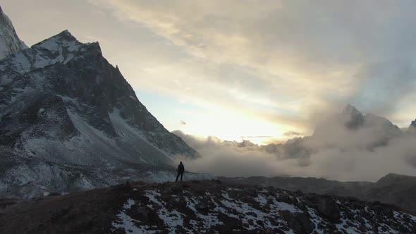 Ama Dablam Mountain and Hiker Man at Sunset. Himalaya, Nepal. Aerial View