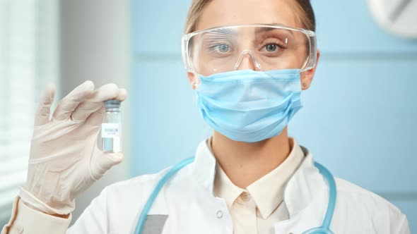 Concentrated young woman doctor in blue disposable face mask