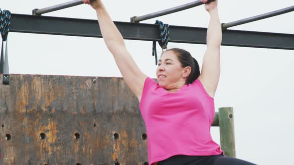 Caucasian woman exercising at bootcamp