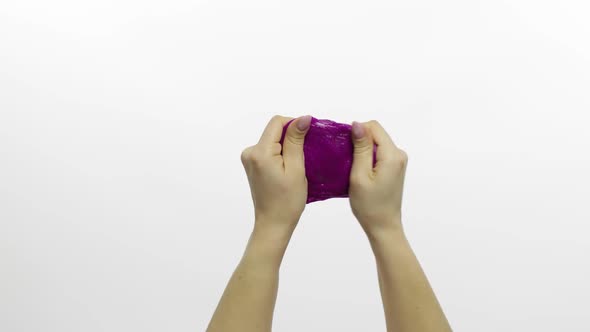 Woman Hands Playing Oddly Satisfying Purple Slime. White Background. Antistress