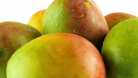 Macro Shot of Rotating Mangoes - White Background