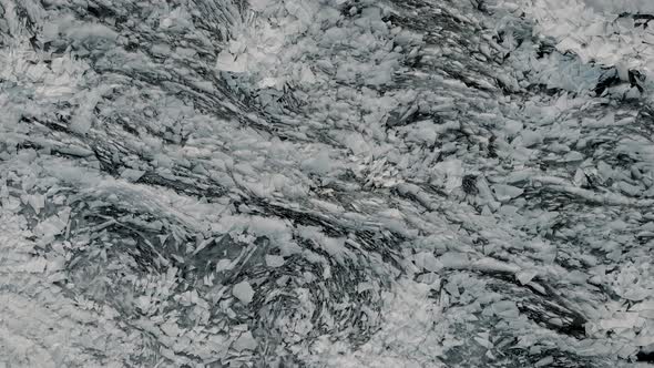 Aerial View of a Frozen River. Fancy Ice Texture, Cold Chained Water. Shards of Ice Stick Out with