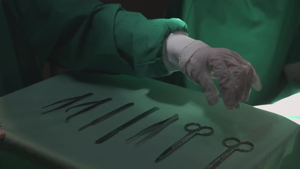 Hands of surgeon specialist holding scalpel and scissors for preparing surgery urgency.