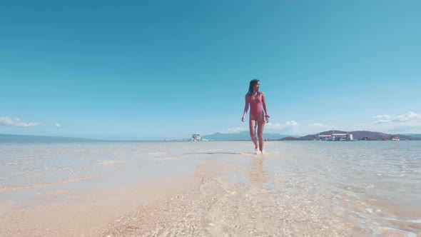 Asian Pretty Girl Walking on Sandbar in Ocean Beach in Manjuyod, Philippines