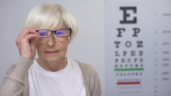 Retired Woman Taking Off Glasses and Showing Case With Contact Lens, Improvement