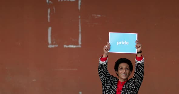 Portrait of woman holding PRIDE placard, Pistoia, Tuscany, Italy