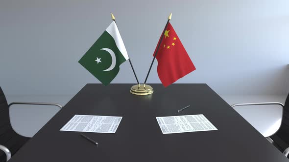Flags of Pakistan and China on the Table