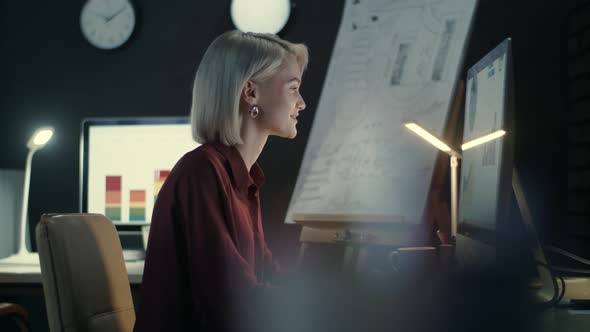 Business Woman Typing on Computer Keyboard in Dark Office.