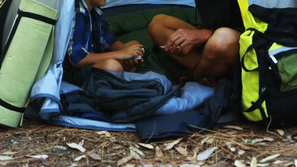 Father and son playing cards in the tent