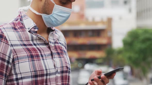 Side view of Caucasian man using his phone during coronavirus pandemic