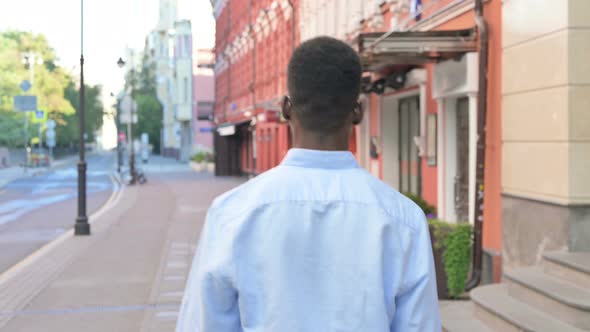 African Man Walking on the Street Back View