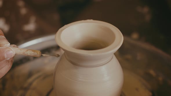 Potter Making Ceramic Vase Using Pottery Tools Indoor Closeup
