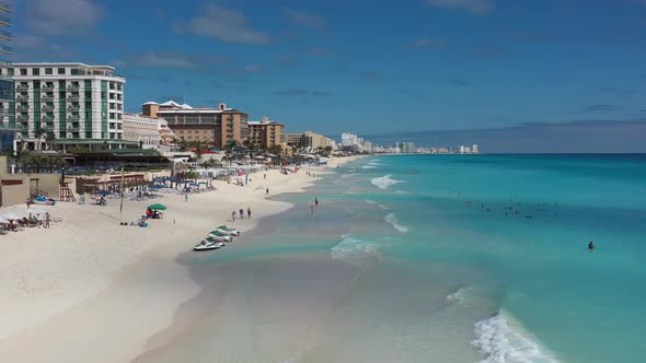 The Pristine Beach of Cancun With a few Bathers on the Caribbean Blue Turquoise Ocean