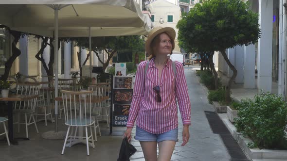 Tourist Woman Walking By The Streets Of Old City Of Kerkyra