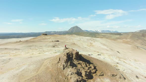 Man Stands on Top of Rock. Iceland. Aerial View