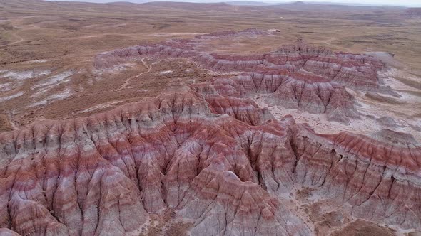 Aerial view of textured red desert in Wyoming flying down