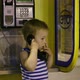 Young boy talking to the phone in a booth - VideoHive Item for Sale