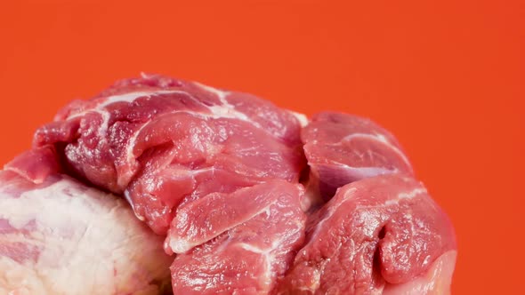 Close-up piece of red meat with fat rotates