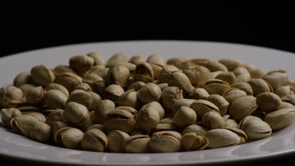 Cinematic, rotating shot of pistachios on a white surface - PISTACHIOS 039