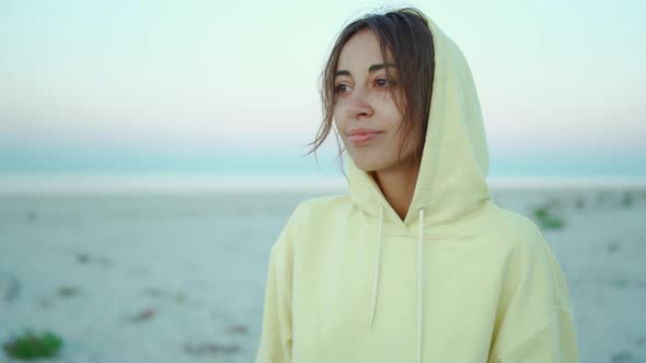 Close Up Portrait with Handheld Camera of Beautiful Candid Peaceful Happy Woman in Yellow Hoodie on