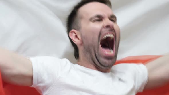 Polish Fan Celebrating While Holding the Flag of Poland