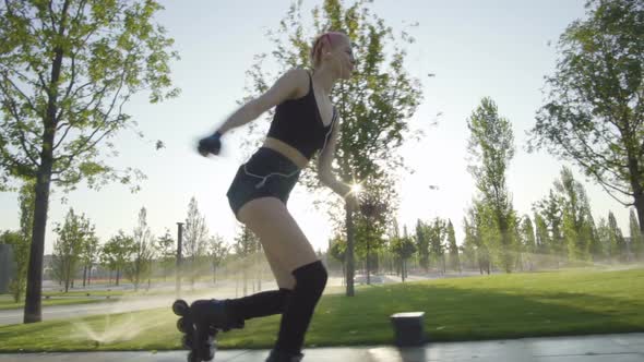 Beautiful Young Woman On Rollerblading In Park At Sunrise