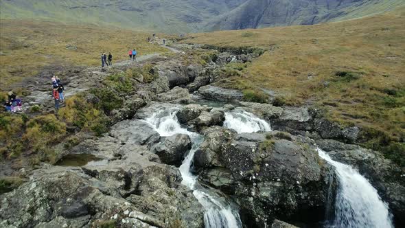 People Walking by the Fairy Pools in the Isle of Skye Scotland