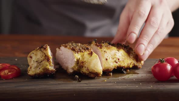 Professional Chef Serving Meat Chicken Breast Grill Steak with Salt Work in a Busy Kitchen Getting