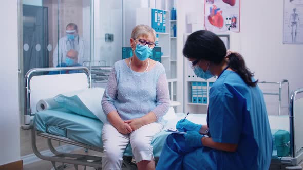 Nurse Questioning Senior Patient