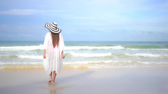 Asian woman enjoy around beautiful beach sea ocean