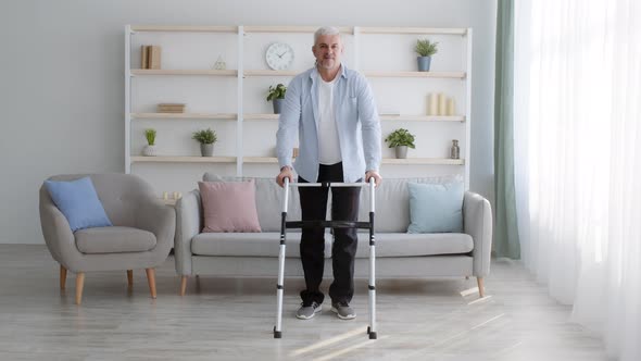 Disabled Man Making Step With Disability Walking Frame At Home