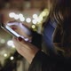 Close up of girl hands holding modern smart phone, woman's hand using cellphone at night city. - VideoHive Item for Sale