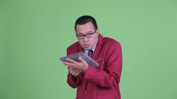 Happy Asian Businessman Using Digital Tablet and Watching Adult Videos
