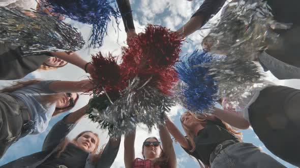 Cheerful Girls in the Meadow Waving Multicolored Cheerleading Pompoms