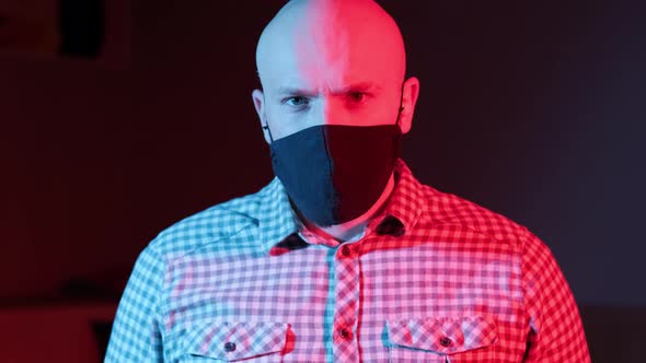 Man with Protective Medical Masklooking at Camera Flashing Red Blue Light