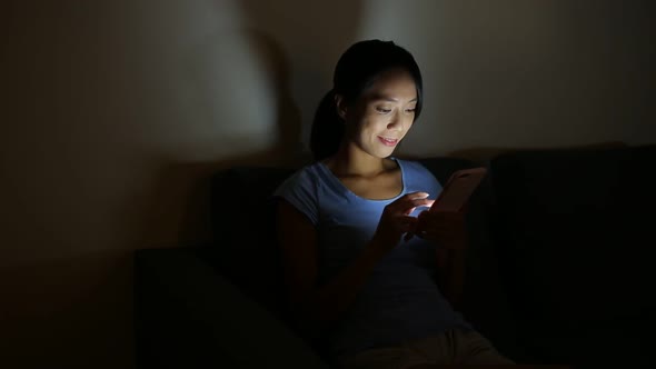 Woman using digital tablet at night