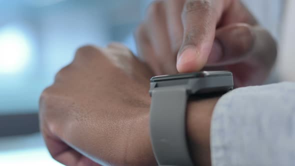 Hands Close up of African Man using Smart Watch