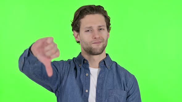 Thumbs Down By Disappointed Young Man on Green Chroma Key